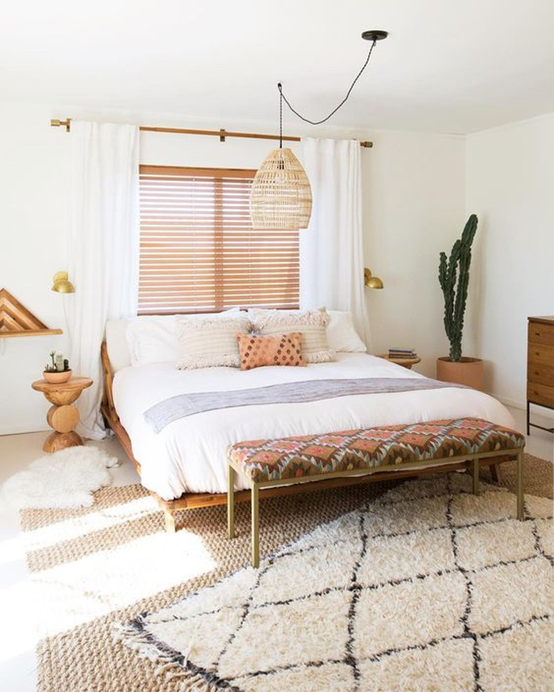 bohemian bedroom lighting idea with woven bamboo pendant hanging above bed