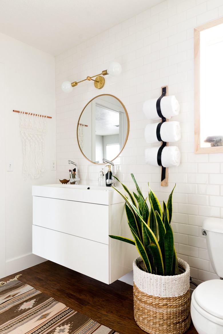 Boho Bathroom Storage in modern boho bathroom with brass details and towel holder