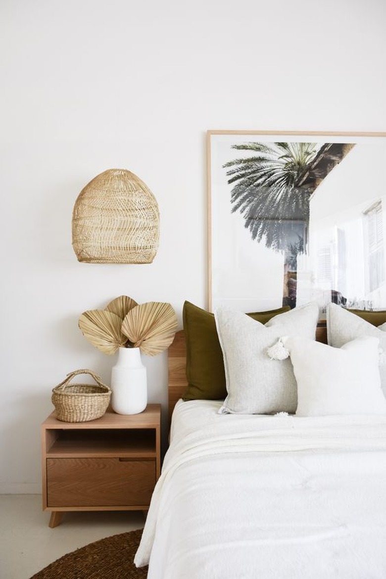 white boho beach bedroom with rattan details and beach print