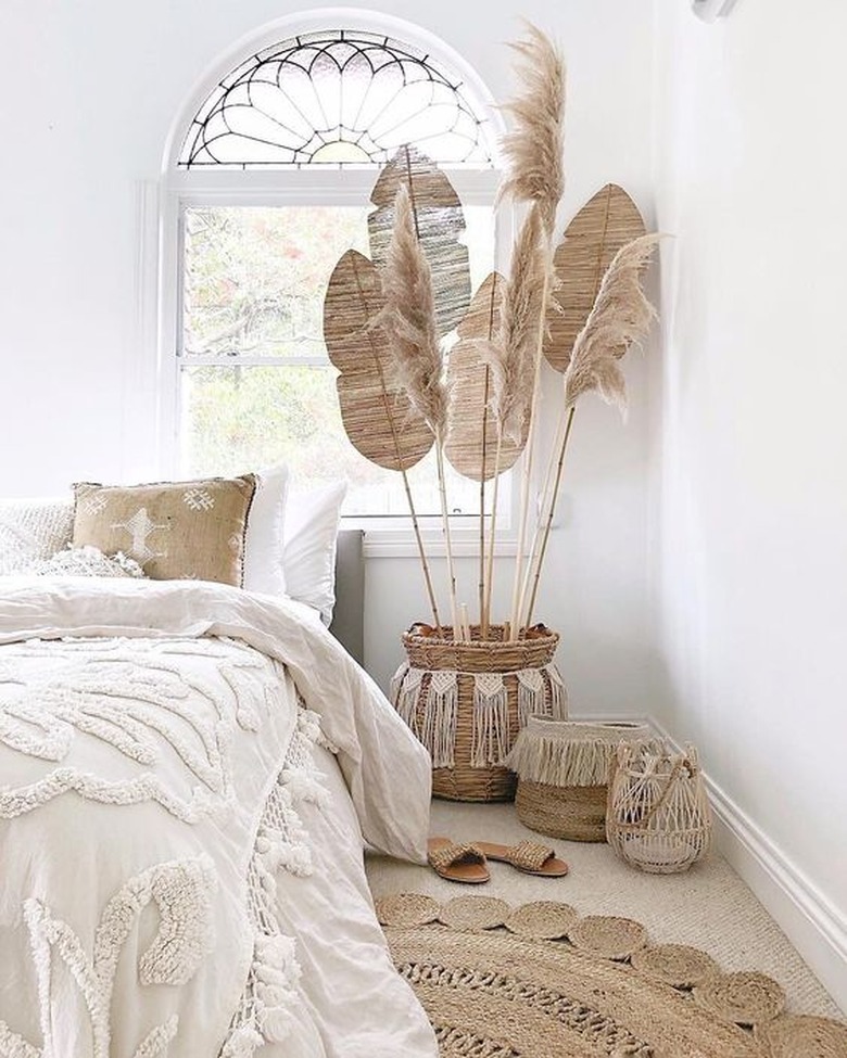 white boho beach bedroom with beach fans and pampas grass