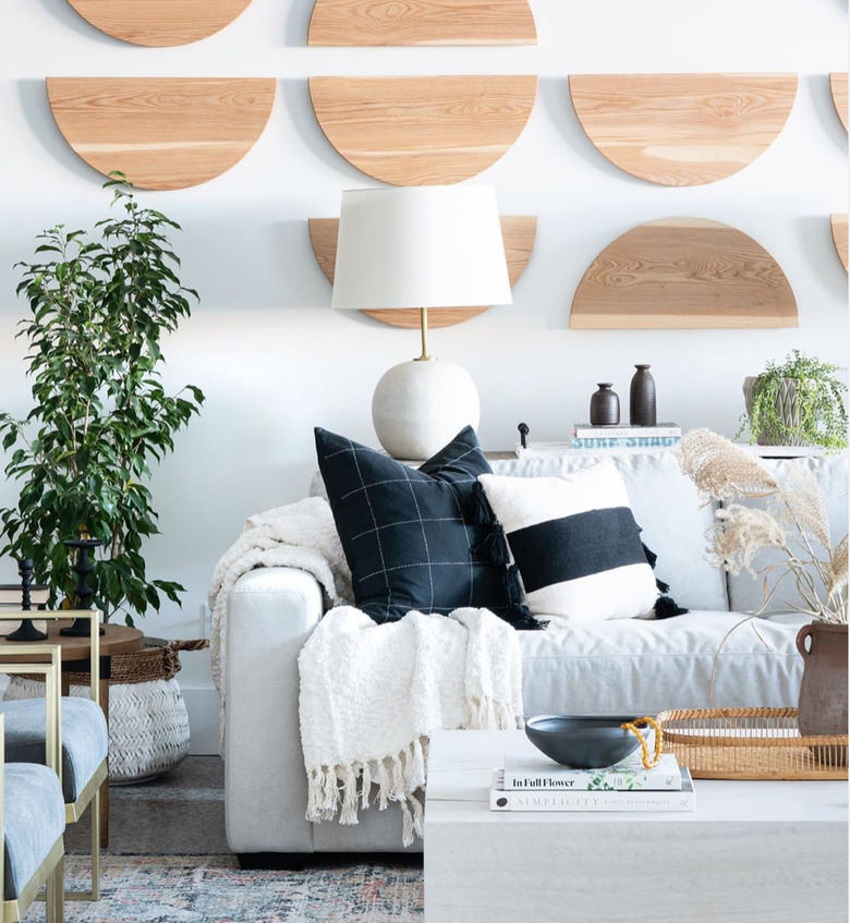 boho coastal living room with wooden half moons on walls