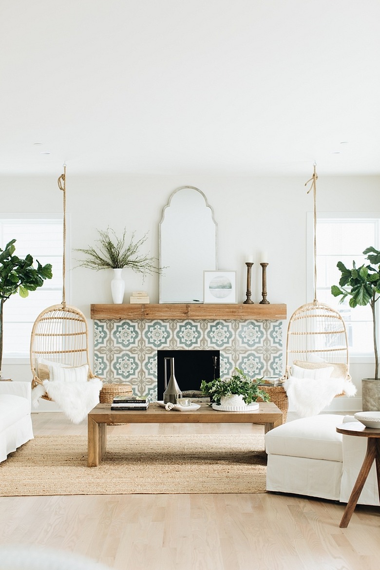 boho coastal living room with rattan swings, moroccan tiled fireplace