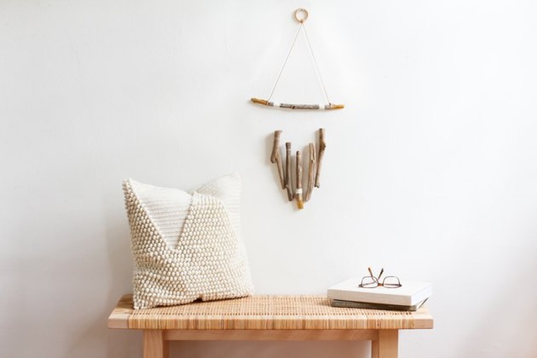 driftwood wall art above bench