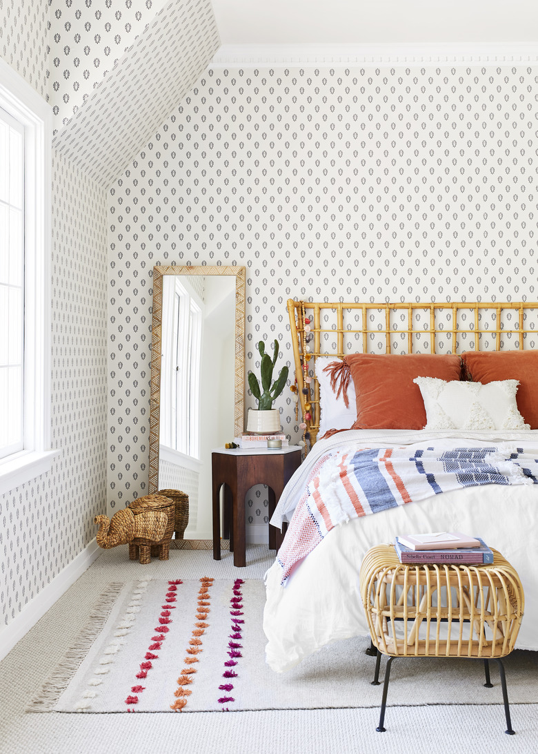 boho girls room with paisley-print wallpaper, rattan bed