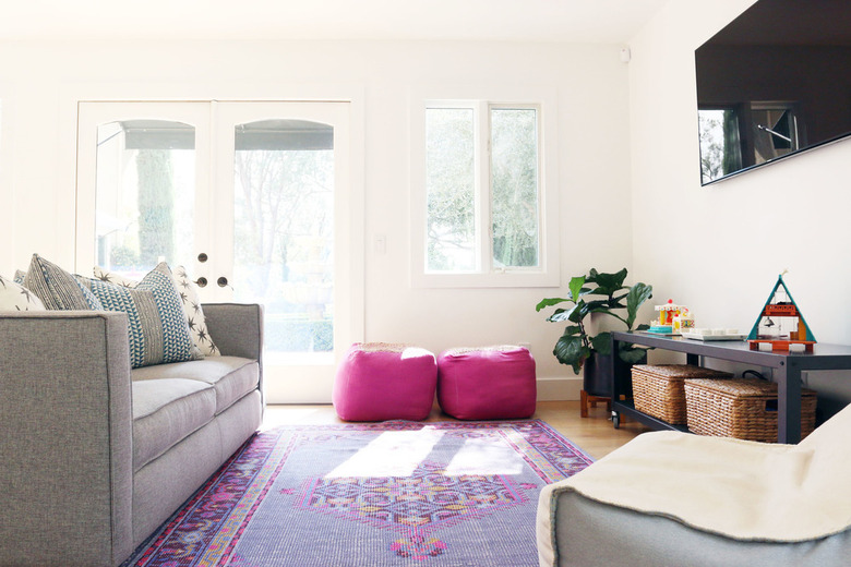 TV room with white walls and punchy accessories for bonus room above garage idea