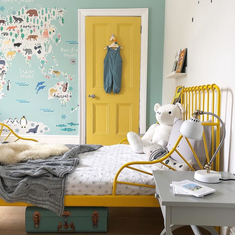 boys bedroom idea with blue map mural and yellow door to match bed