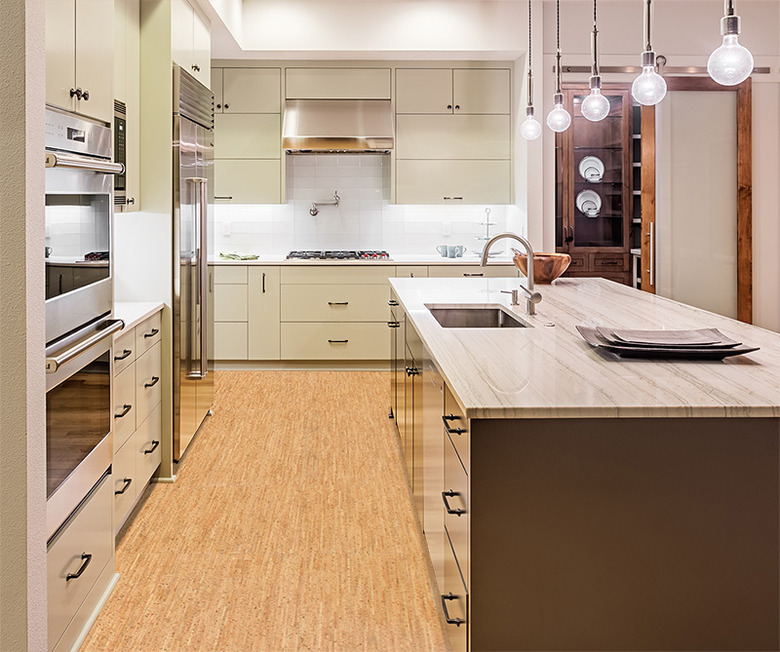 Cork flooring in contemporary kitchen with island and pendant lighting