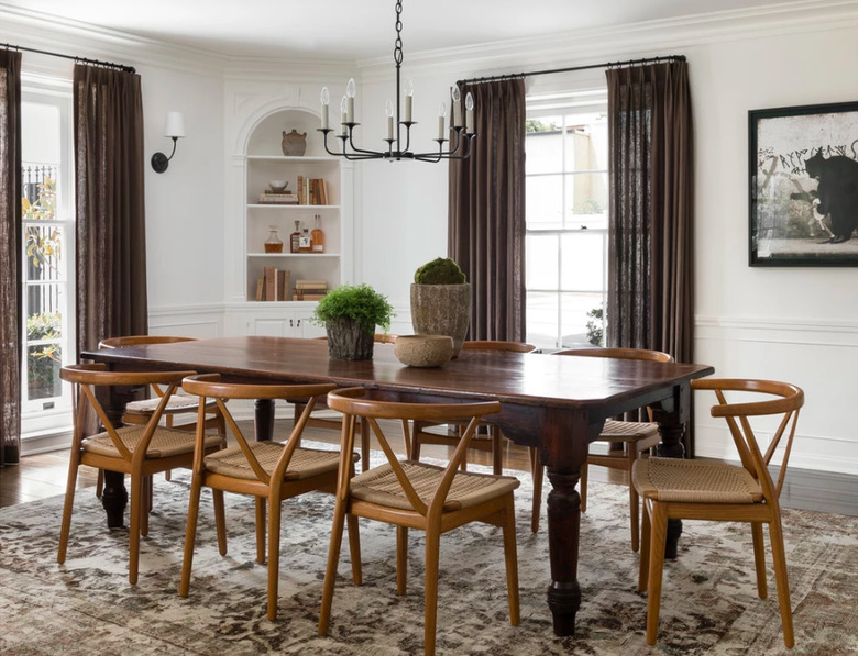 dining space with wood chairs and black chandelier