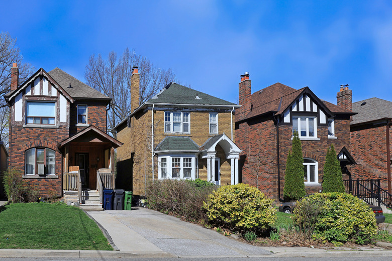 Residential street with older two story brick detached houses in spring