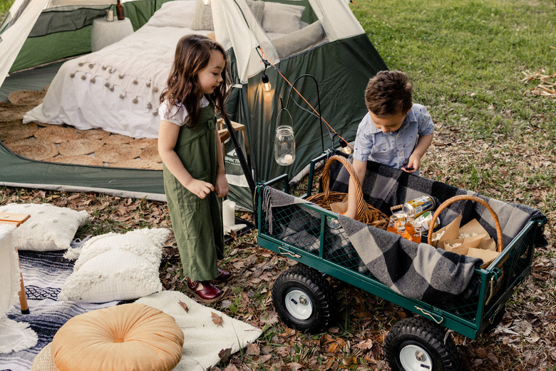 Kids next to tent camping or 