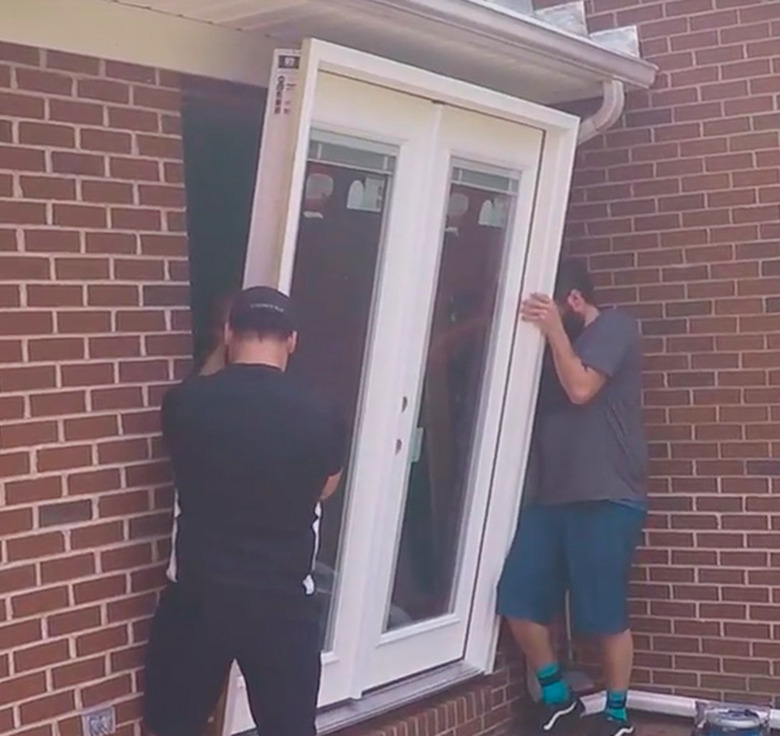 Installing a patio door in a brick wall.