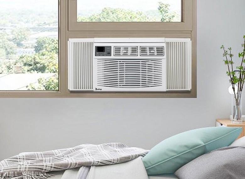 White window air conditioner in gray bedroom