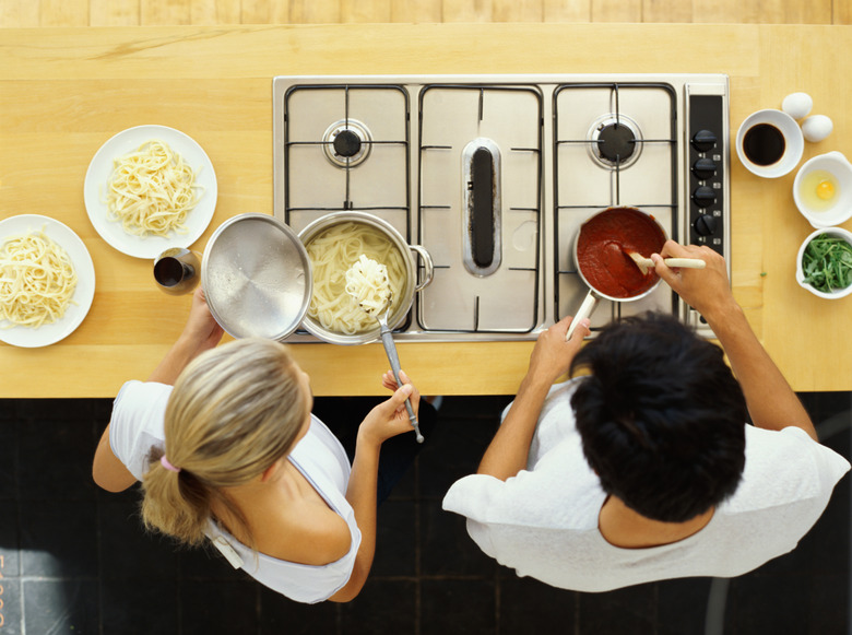 high angle view of a young couple cooking food in the kitchen