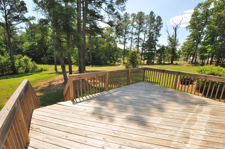 Large wooden deck overlooking yard.