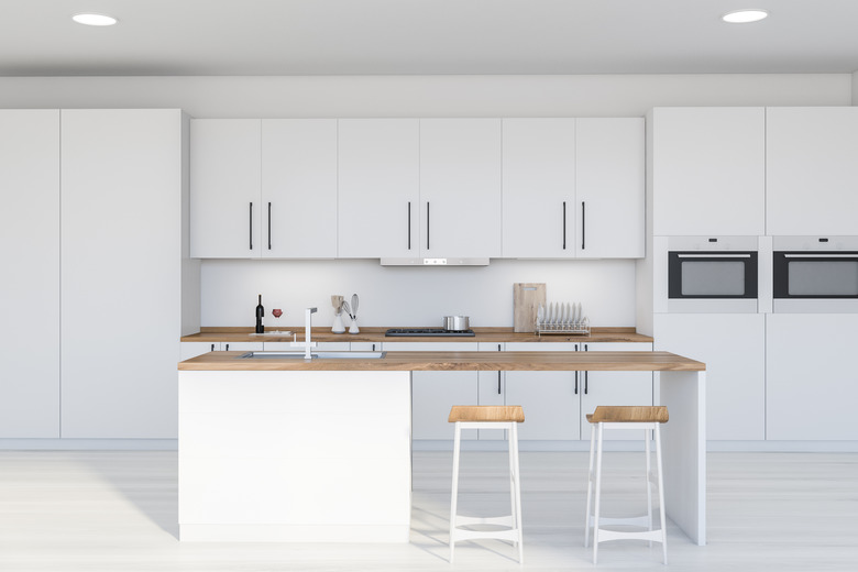 Modern white kitchen interior with bar