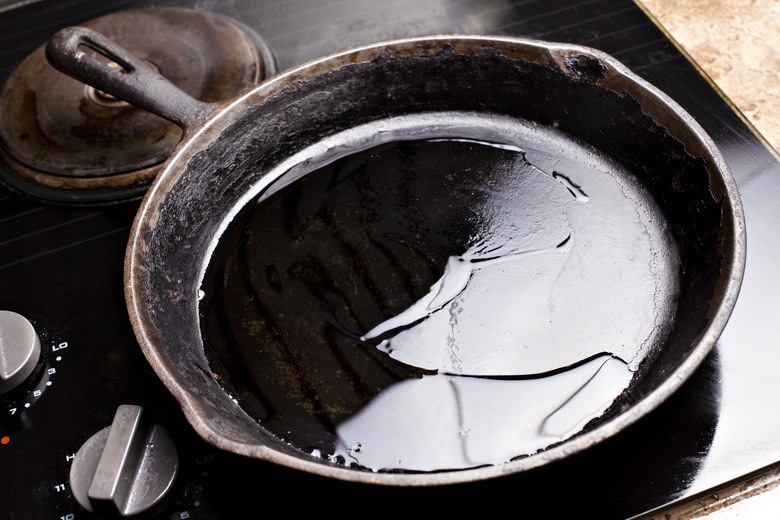 Old cast iron skillet with oil