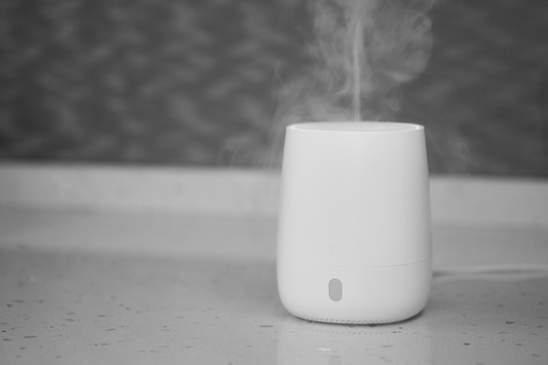 Air humidifier stands on tabletop surface