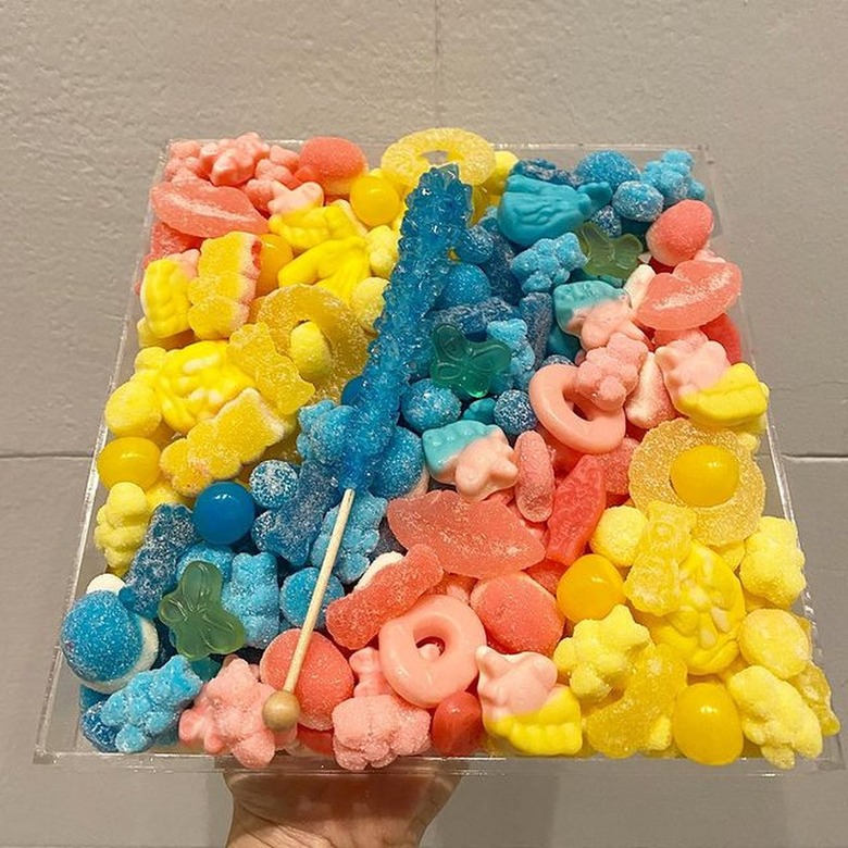 person holding board with candy