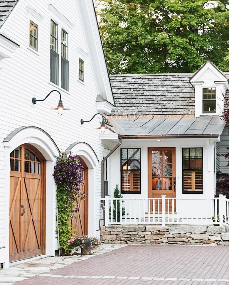 white house exterior with wood carriage style garage doors