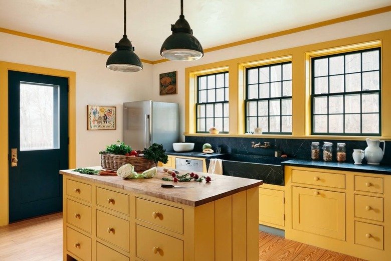 yellow kitchen cabinet idea with black trim and small island