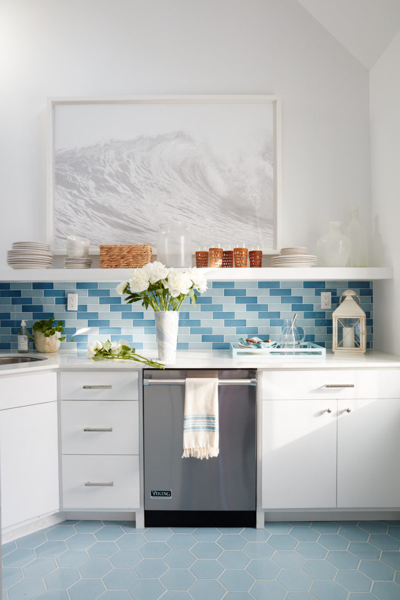 Kitchen with white cabinets and blue floor tile and backsplash