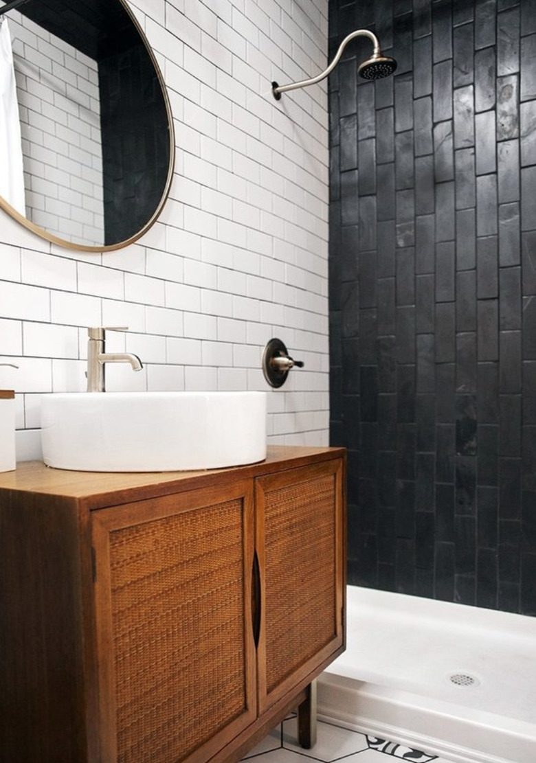 Black subway tiles with black grout in shower.