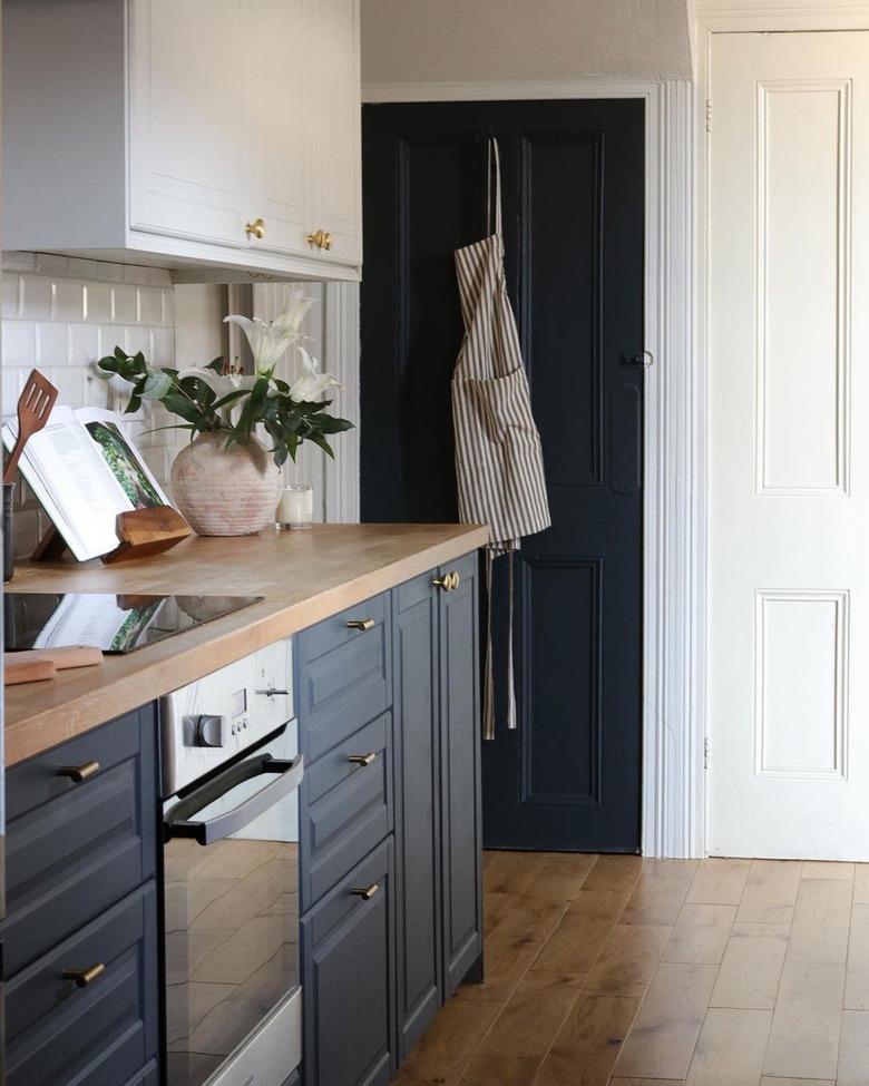 navy blue and white two tone chalk painted kitchen cabinets