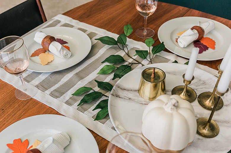 Turn a plain white table runner into a work of art using paint and a mini roller.