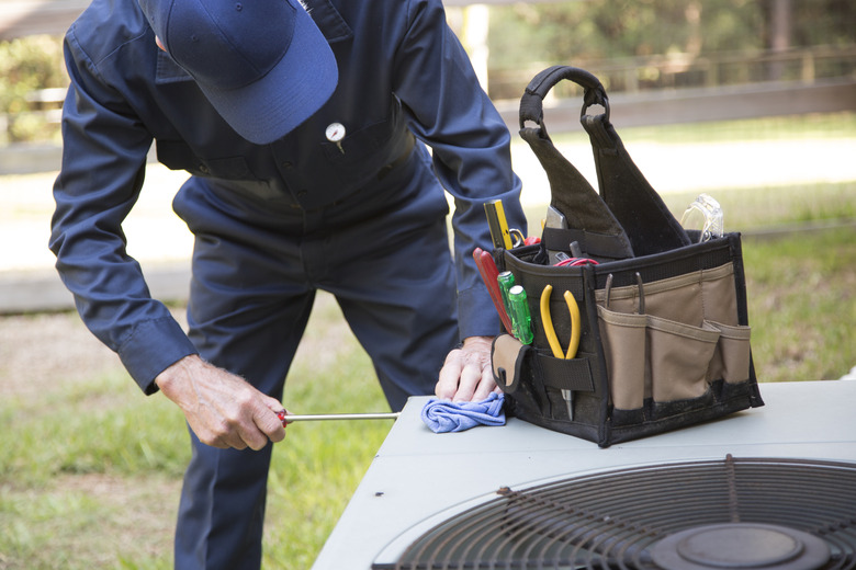 Technician services outside AC units and generator.