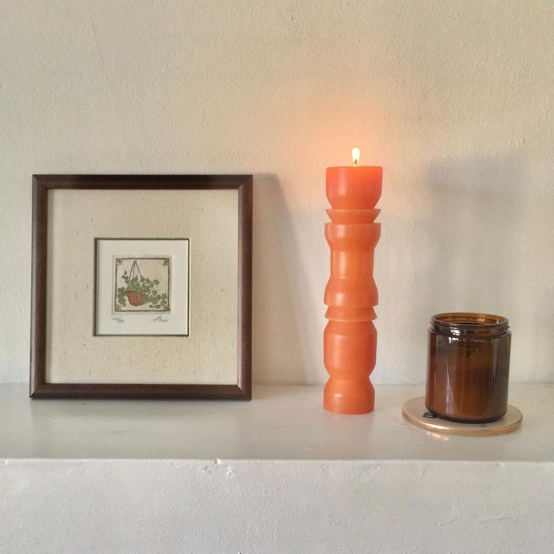 shelf with framed art, and candles