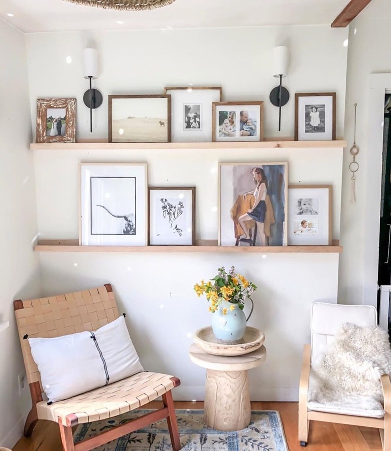 sitting area with two chairs and ledges with framed art