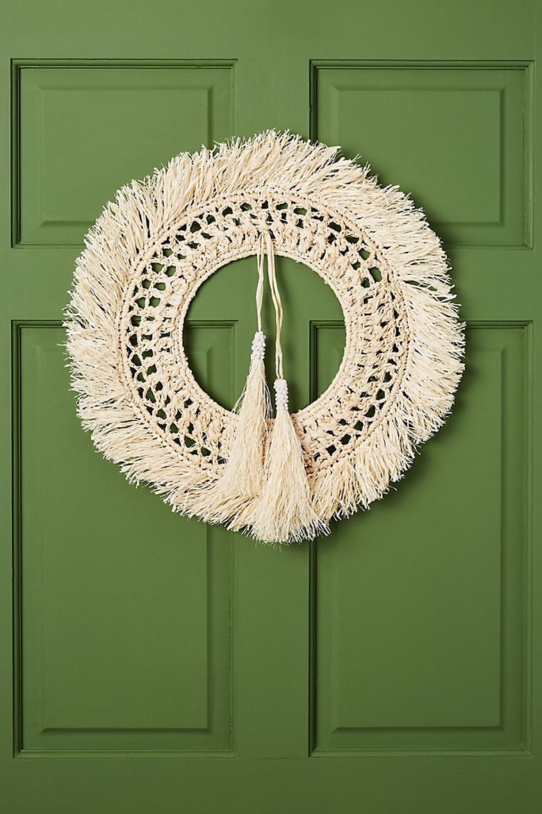 Christmas Door Decorations with Straw wreath on green door.