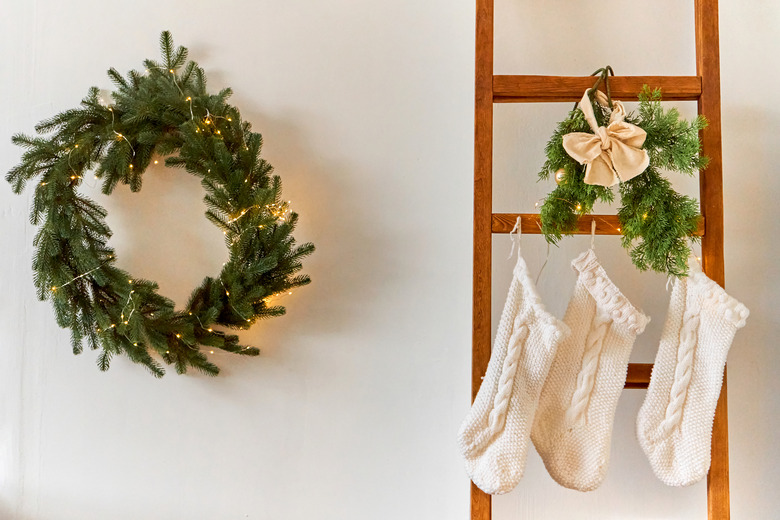 Festive Christmas decorations of a light room with a Christmas tree and knitted socks for Santa's gifts