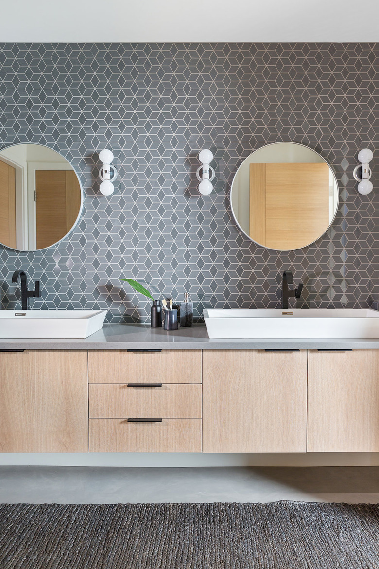 Midcentury modern style bathroom with patterned tile accent wall and floating vanity cabinet