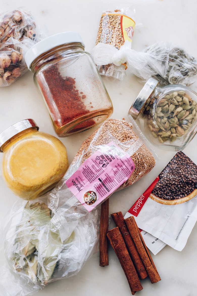 Remove everything from spice cabinet to clean and organize