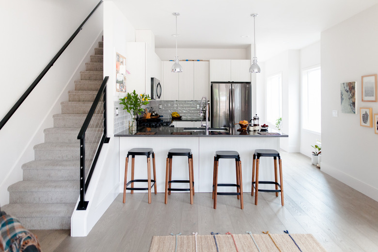 modern kitchen with barstools and neutral colors