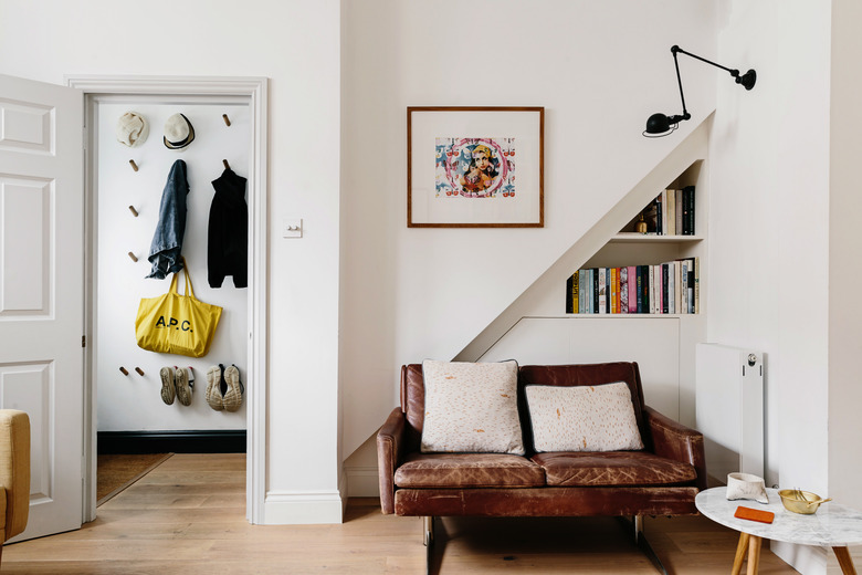 hallway closet idea with wall hooks for jackets, bags, hats, and shoes