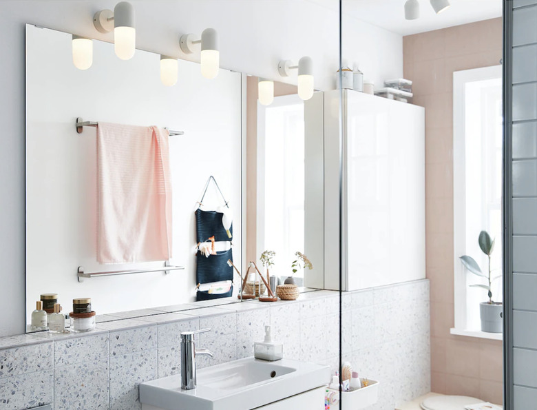 coastal bathroom lighting idea with wall sconces in pink and white space