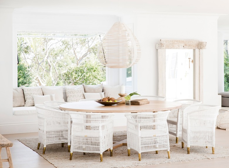 white coastal farmhouse dining room with rattan dining chairs