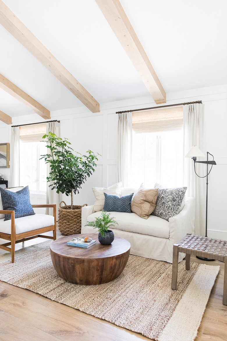 white coastal farmhouse living room with wood coffee table