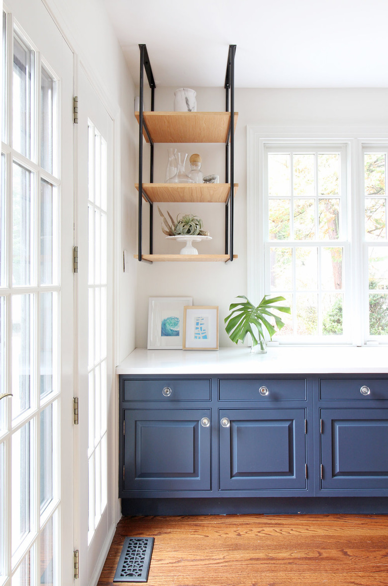 Coastal paint colors in kitchen with navy blue cabinets and open shelving