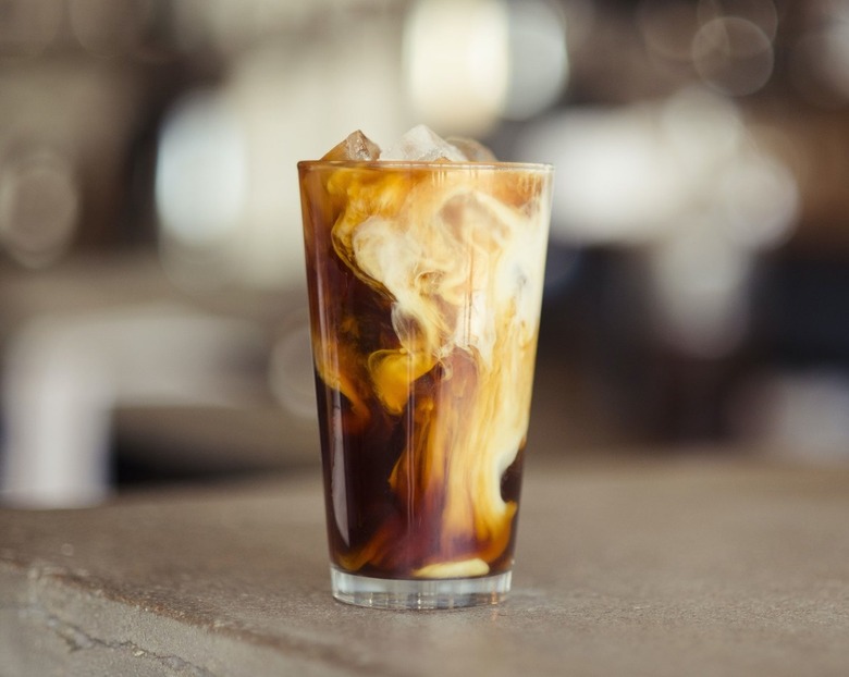 coffe milk swirl in glass on table