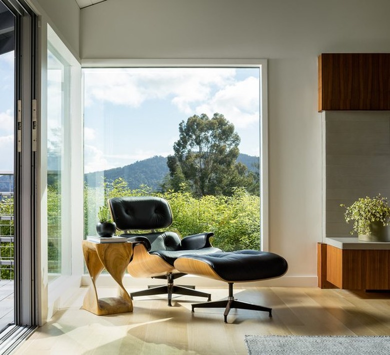 An Eames Lounge Chair provides a comfortable place to sit behind sprawling views of the Northern California landscape.