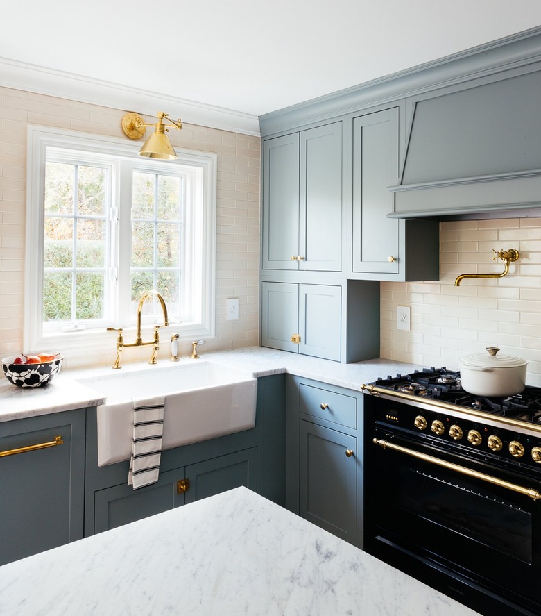 Blue kitchen cabinets with butter yellow ceiling tiles