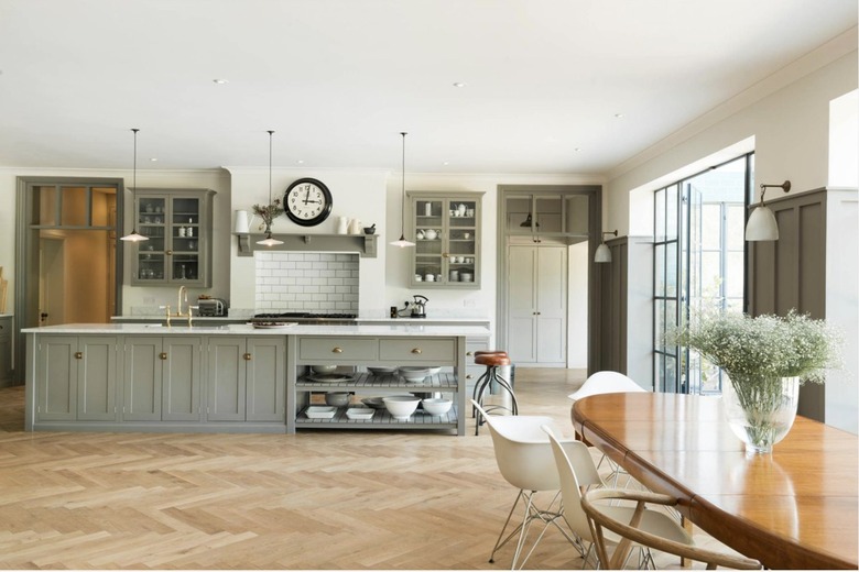 Minimalist kitchen with gray cabinets and black accessories