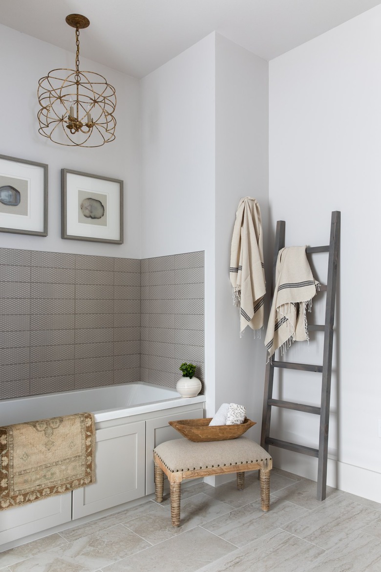 White bathroom with gray tile backsplash and flooring