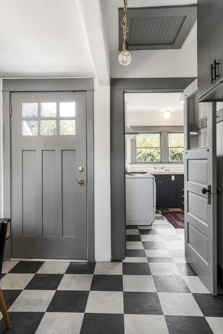 Corner with black and white checkered floor, light gray doors and white walls