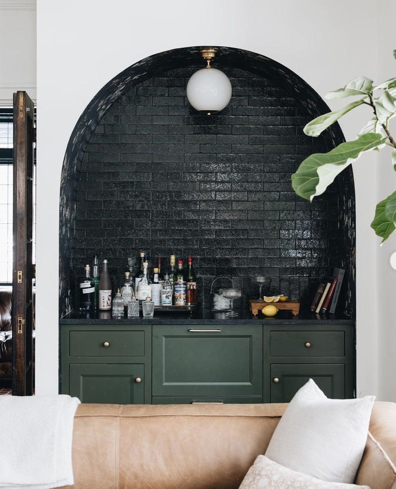 inset bar with hunter green tile and cabinets