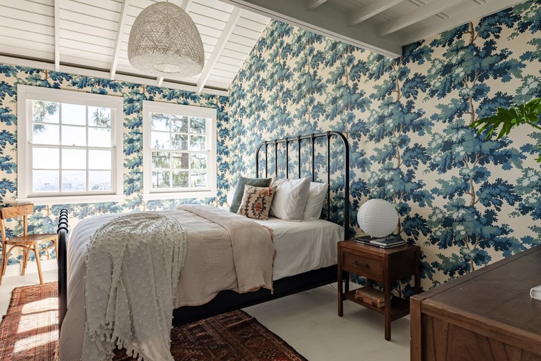 bedroom with blue printed wallpaper