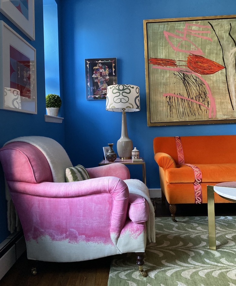 room with electric blue walls and orange and pink furniture